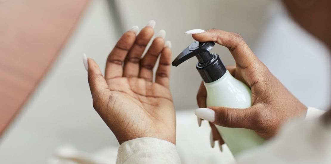 African American Woman Using Hand Cream