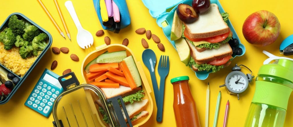 Concept of tasty eating with lunch boxes on yellow background