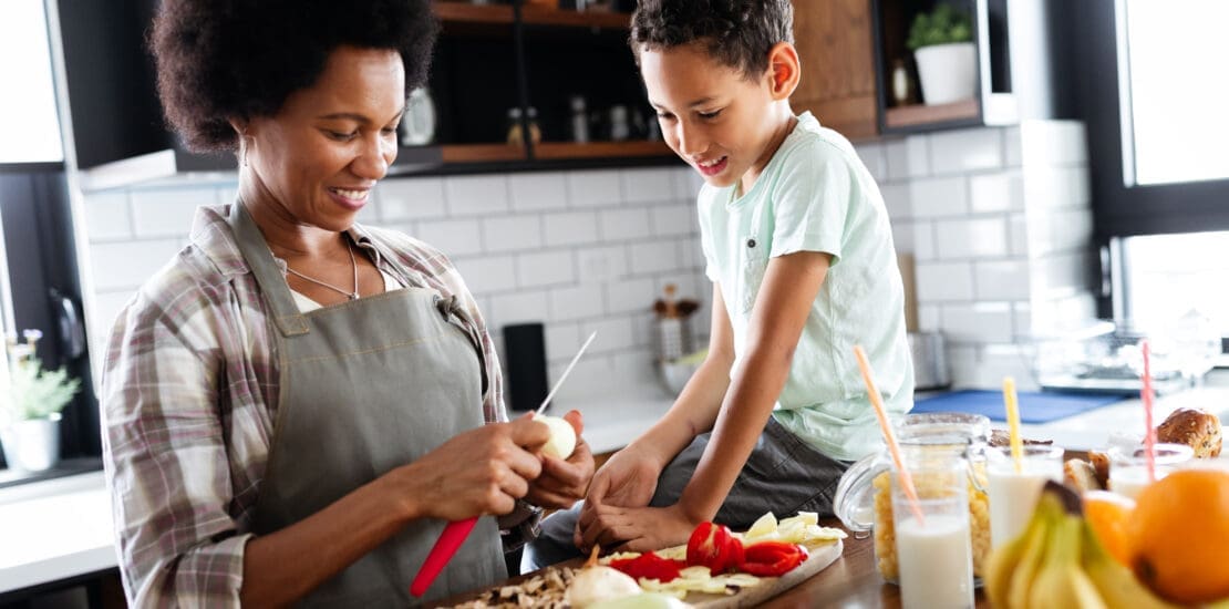 Mother and child having fun preparing healthy food in kitchen