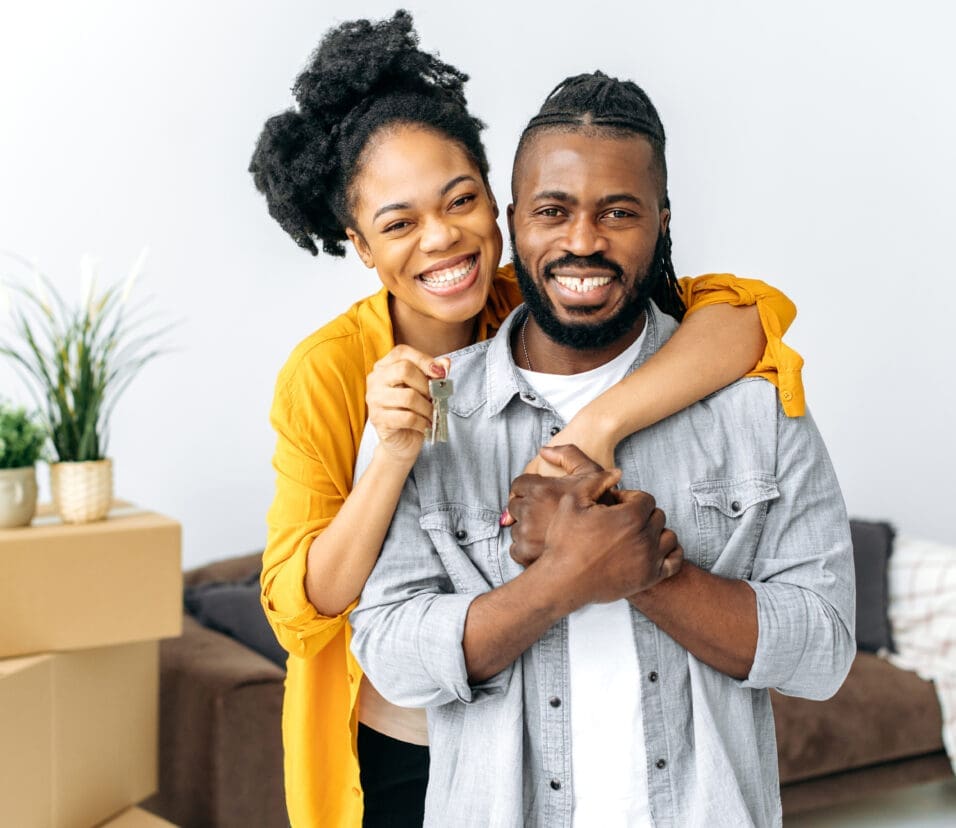 New housing, relocation. Happy joyful african american family, black couple hugging while standing