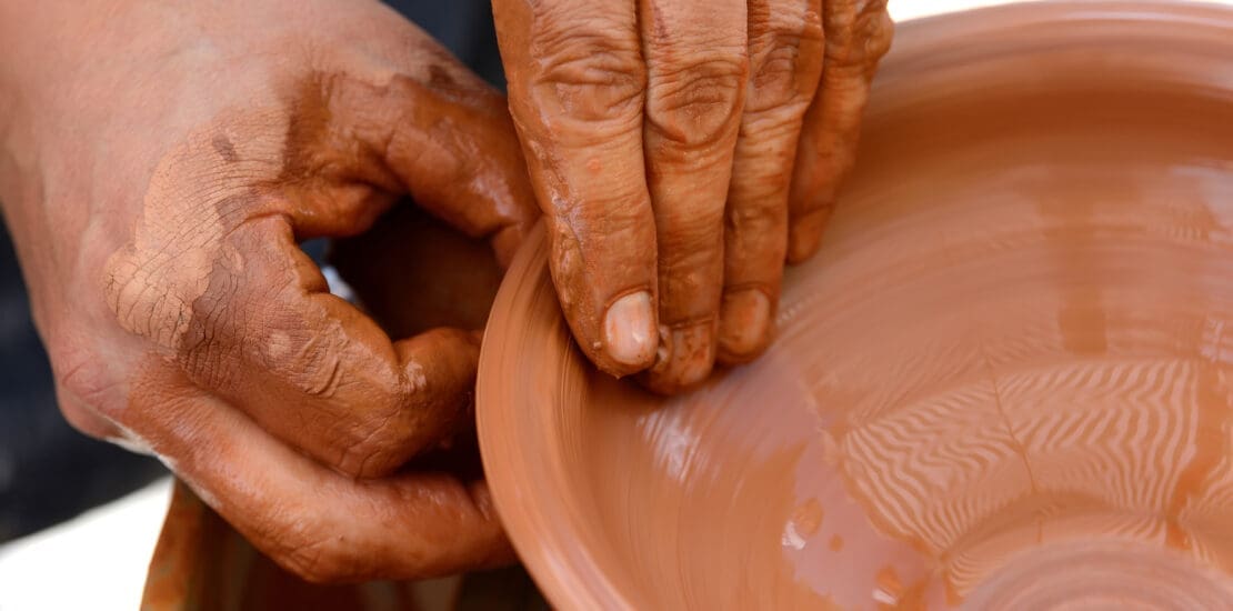 Potter making ceramic pot on the pottery wheel