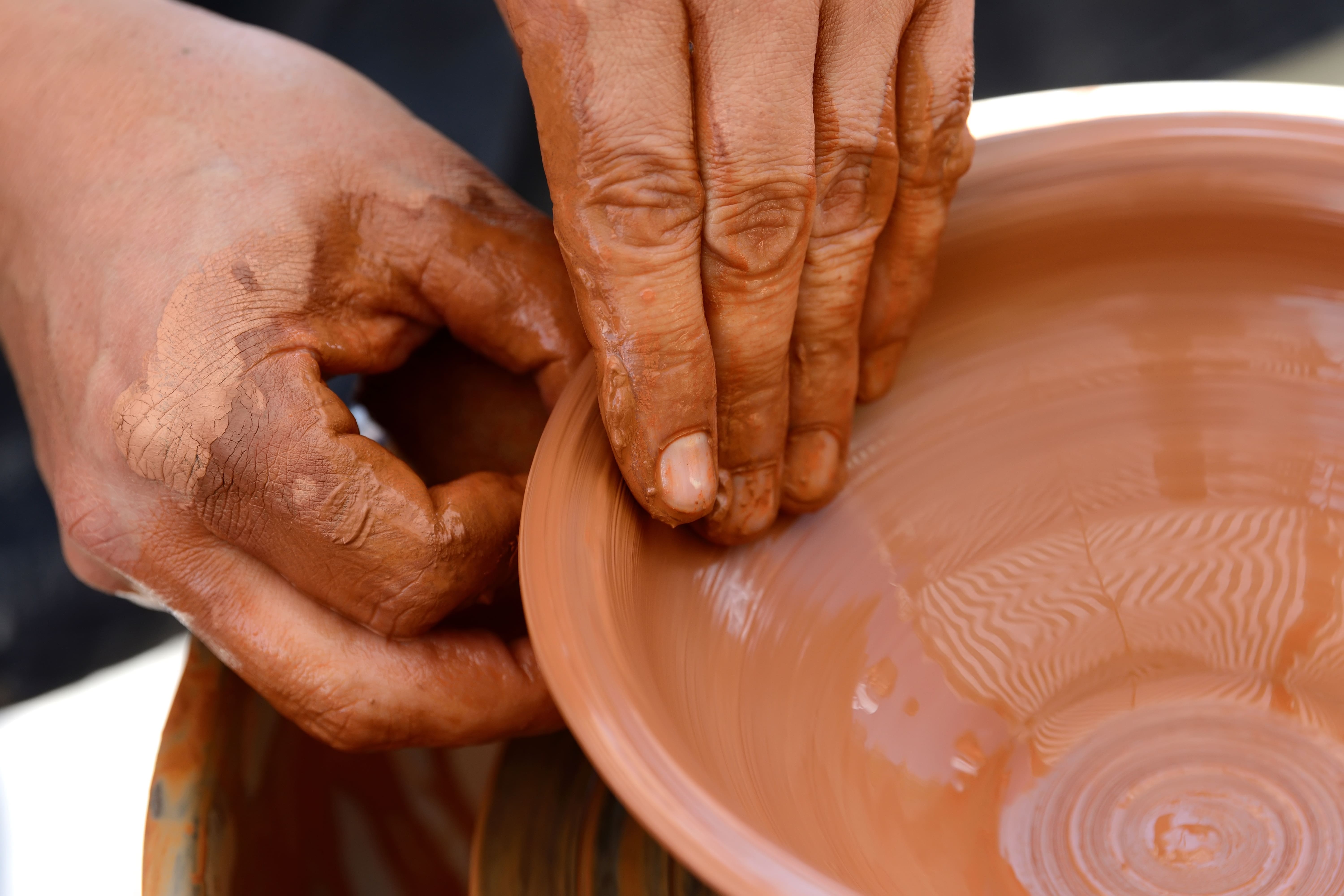 Potter making ceramic pot on the pottery wheel