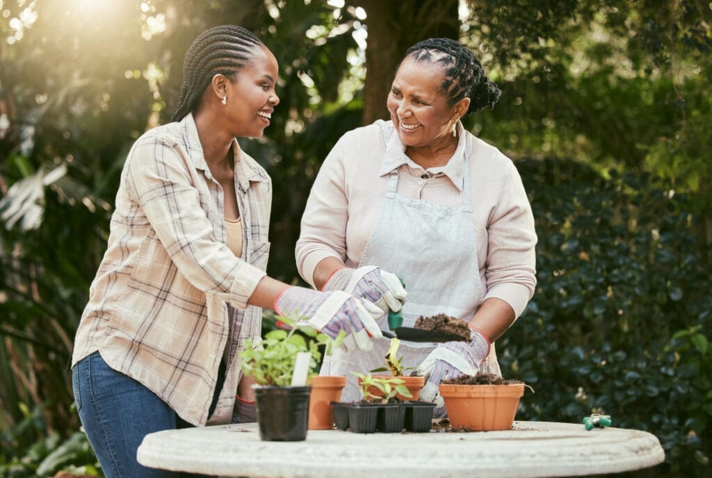 Shot of a mother and daughter gardening together in their backyard